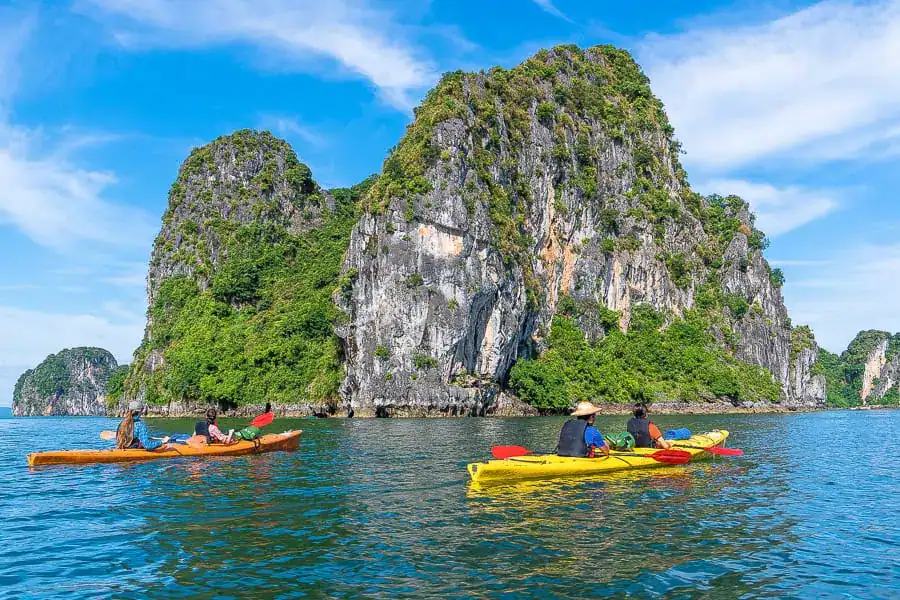 Kayaking Bai Tu Long Bay past karst islands is one of the best things to do in Halong Bay or Bai Tu Long Bay while cruising.