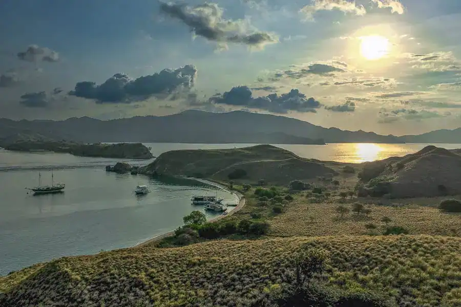 Sunset overlooking a tranquil bay in Komodo National Park during our Komodo liveaboard trip.