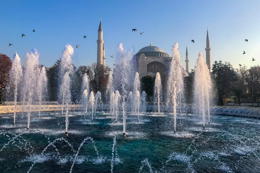 Water fountains shoot into the air with the Hagia Sophia in the background.