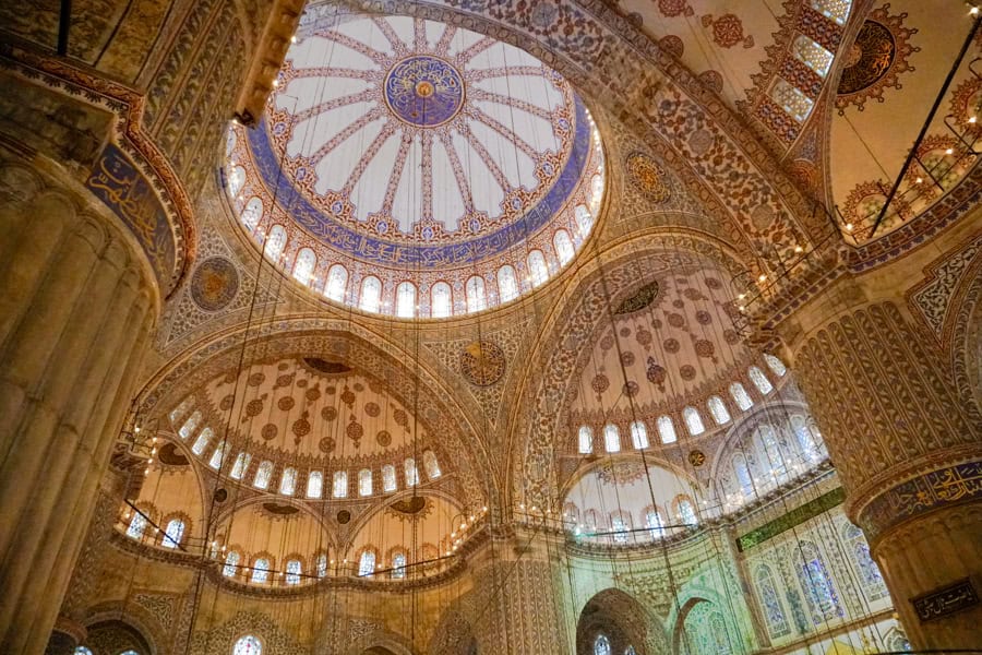 Ornately tiled arches, domes and columns in the Blue Mosque, one of the most iconic Istanbul attractions.