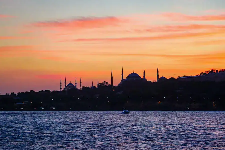 Silhouette of Old City mosques at sunset on the ferry to Kadıköy - just one option for where to stay in Istanbul!