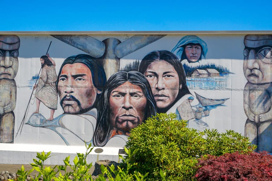 A colourful indigenous themed mural covers a wall in Chemainus – an essential stop as you road trip Vancouver Island.