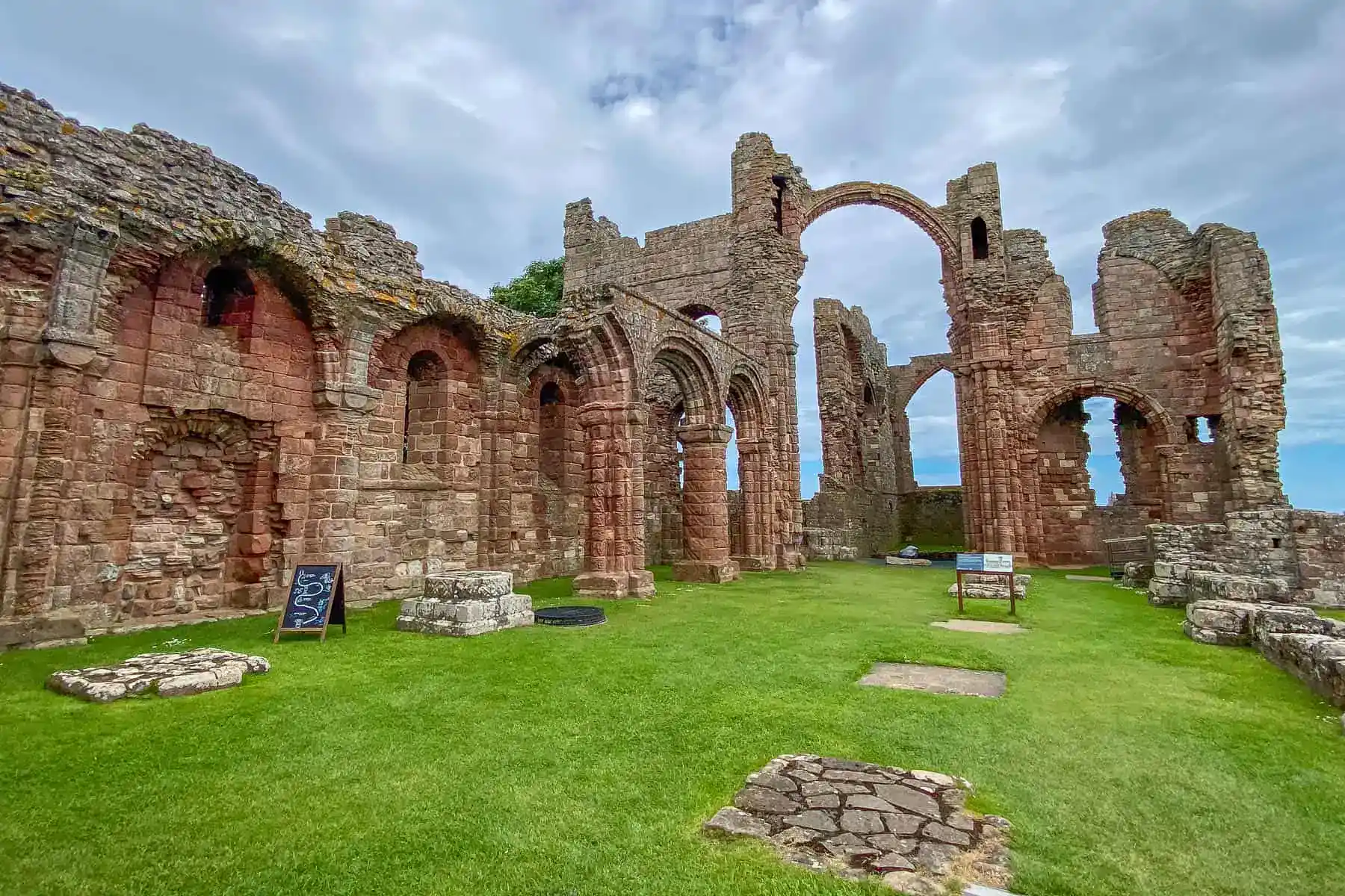 The crumbling ruins of Lindisfarne Abbey sit on Holy Island, one of the highlights of a Northumberland 250 road trip.