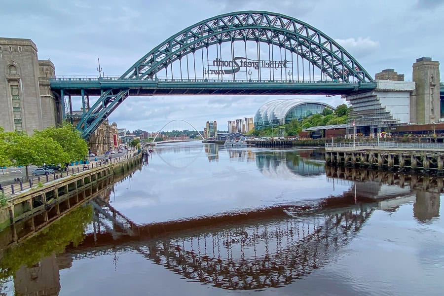 Views of the Tyne Bridge reflected in the river while visiting Newcastle after our Northumberland 250 road trip.