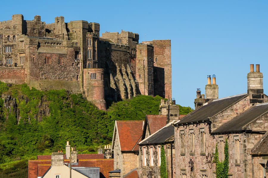 Views toward hulking Bamburgh castle from across the rooftops in the nearby town of Bamburgh.