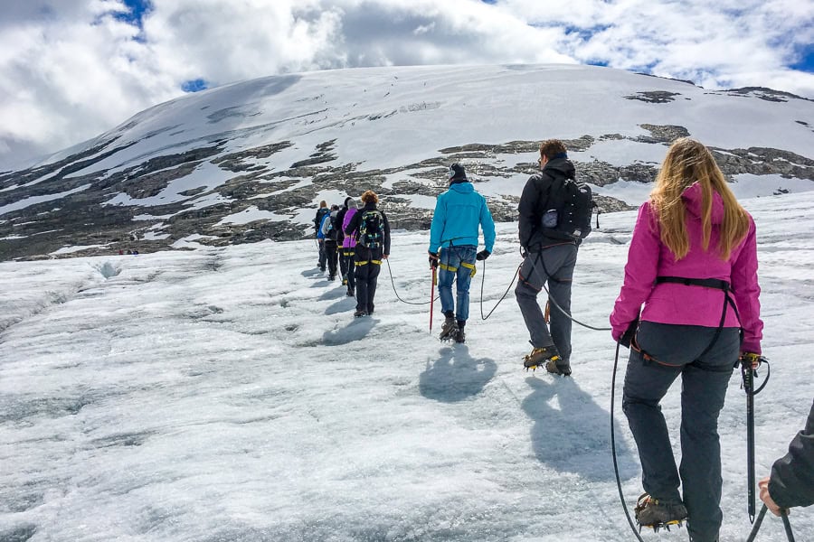 A group in colourful winter clothes are roped together as they hike up a glacier in Norway’s Jostedalsbreen National Park.