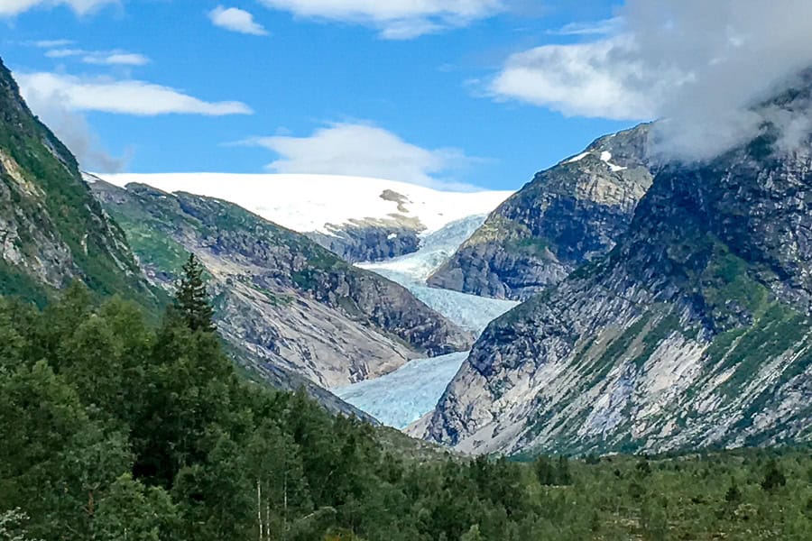 View across forest and mountains to the snaking ice of Nigardsbreen – another popular glacier hike in Norway.